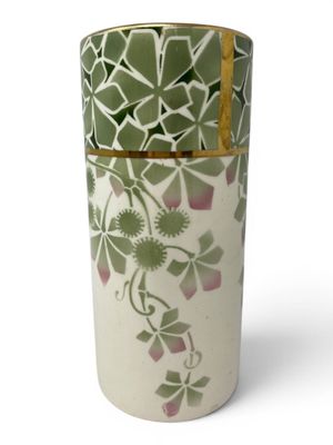 a vase with a green and white design on it