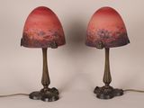 pair of red glass lamps sitting on top of a table