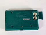 an image of a green electronic device sitting on top of a white surface