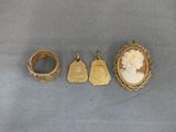 three gold rings and a ring with a picture of a woman