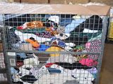 a cart full of clothes that is sitting in a warehouse