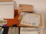 a lot of stamps on a table with a box