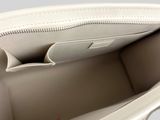 the inside of a white purse with a zipper on the inside