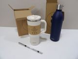 a cup of coffee and a bottle of water on a table