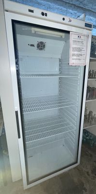 an empty refrigerator in the middle of a room