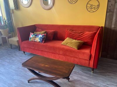 a red couch and a coffee table in a living room