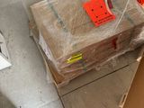 a pile of boxes sitting on the floor next to a microwave