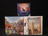 three board games that are sitting on a table