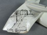 a white plate with a picture of a house on it