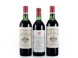 three bottles of wine sitting next to each other on a white surface