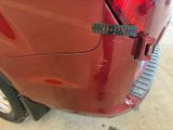 a close up of a red car with a sticker on the back of it