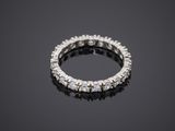 a diamond eternity ring on a black surface
