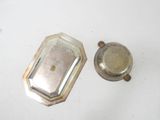 a silver plate and a silver cup on a white table