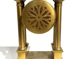 a gold clock that is sitting on a table