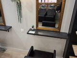 a picture of a hair salon with chairs and mirrors