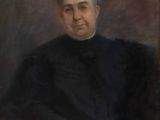 portrait of a man in a black coat sitting in a chair