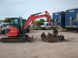 an image of a small excavator in a parking lot