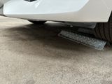 a close up of a car ' s bumper and tire treads