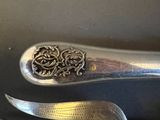 two spoons and a knife sitting on a table