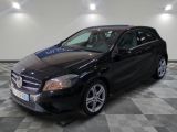 the mercedes cla is parked in a garage with a checkered floor