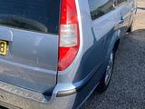 a silver van that is parked in a parking lot