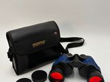 a close up of a pair of binoculars on a white surface