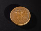 an image of a gold coin on a black surface