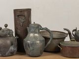 many different types of vases and bowls on a table