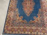 an image of a blue rug with a medallion design on it