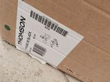 a cardboard box with a sticker on it sitting on the ground