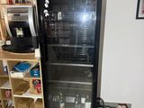 a refrigerator that is sitting in the corner of a room