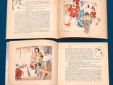 two open books with pictures of people on them on a blue table