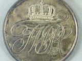 a silver medal with a red ribbon and a crown on it