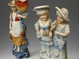 two figurines that are standing next to each other