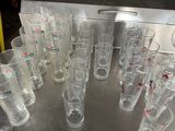 a lot of glasses sitting on a table in a room