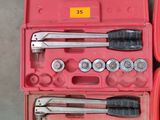 a red tool box with tools in it on a table