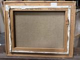 an old picture frame sitting on top of a wooden table