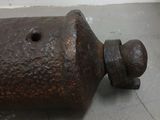 a rusted metal object on the floor of a room