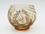 an antique glass bowl with gold and white designs on it