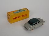 a toy car that is sitting next to a box of dirt toys