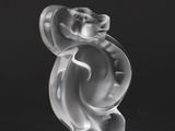 a glass figurine of a bear on a black background