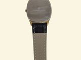 a watch that is sitting on a white surface