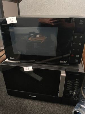 two microwaves stacked on top of each other on the floor