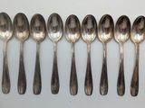 six spoons are lined up in a row on a white surface