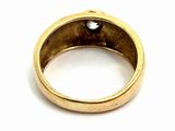 a close up of a gold ring with a black diamond in it