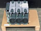 four power supply units on a pallet on the ground