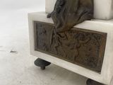 a statue of a woman sitting on a bench