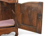 an old wooden cabinet with a checkered seat in it