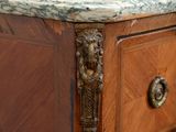 a marble top on a wooden chest of drawers