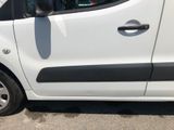 a small white van parked on the side of the road